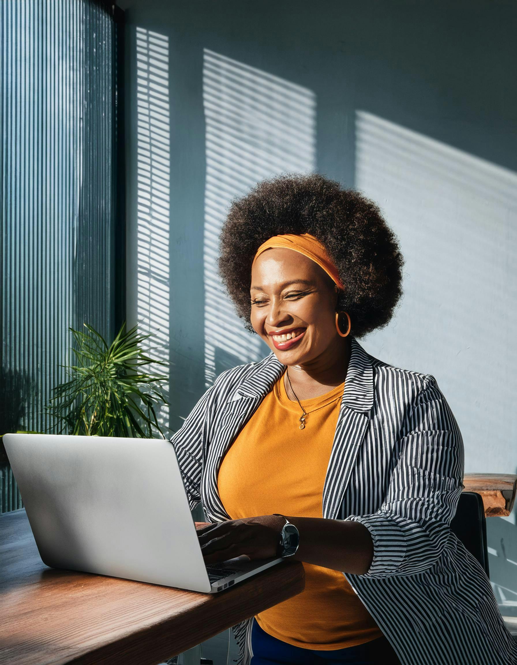 Confident Businesswoman Smiling at Laptop